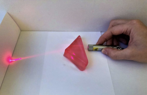 Refraction of red light emitted from a laser pointer by a triangular jelly lens.